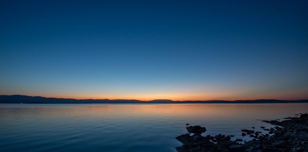 body of water under blue sky during daytime