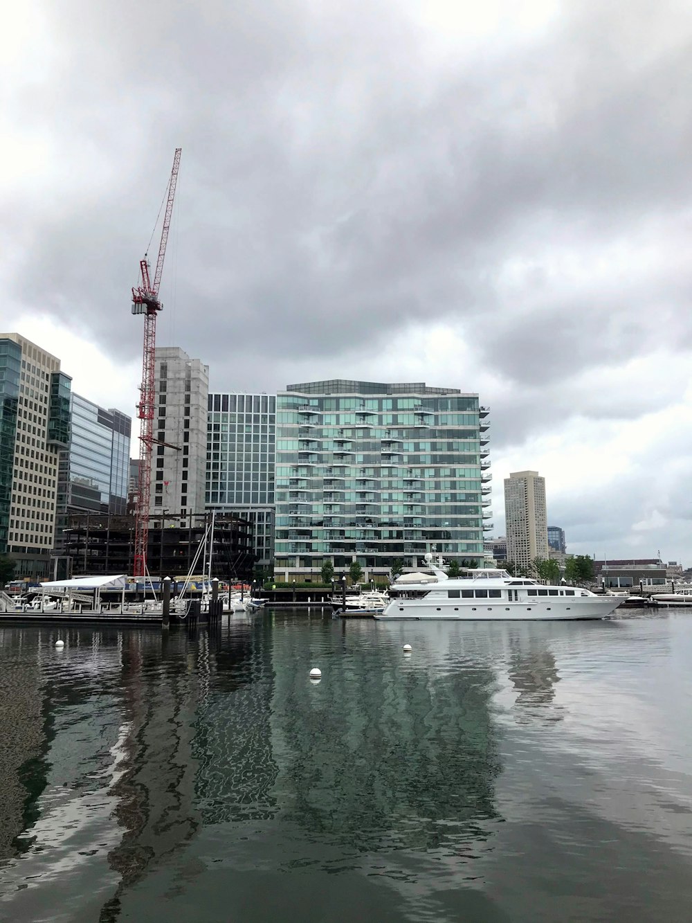 white boat on water near city buildings during daytime