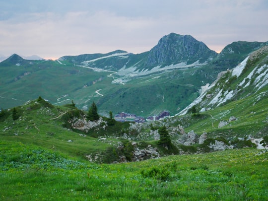 green grass field and mountains during daytime in La Plagne-Tarentaise France