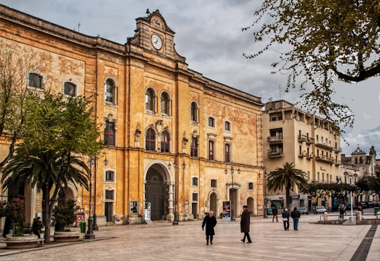 people walking near brown concrete building during daytime in Palombaro Lungo Italy