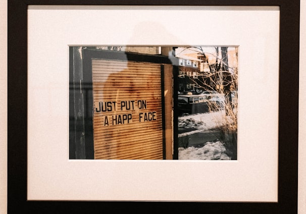 black wooden framed painting of city skyline