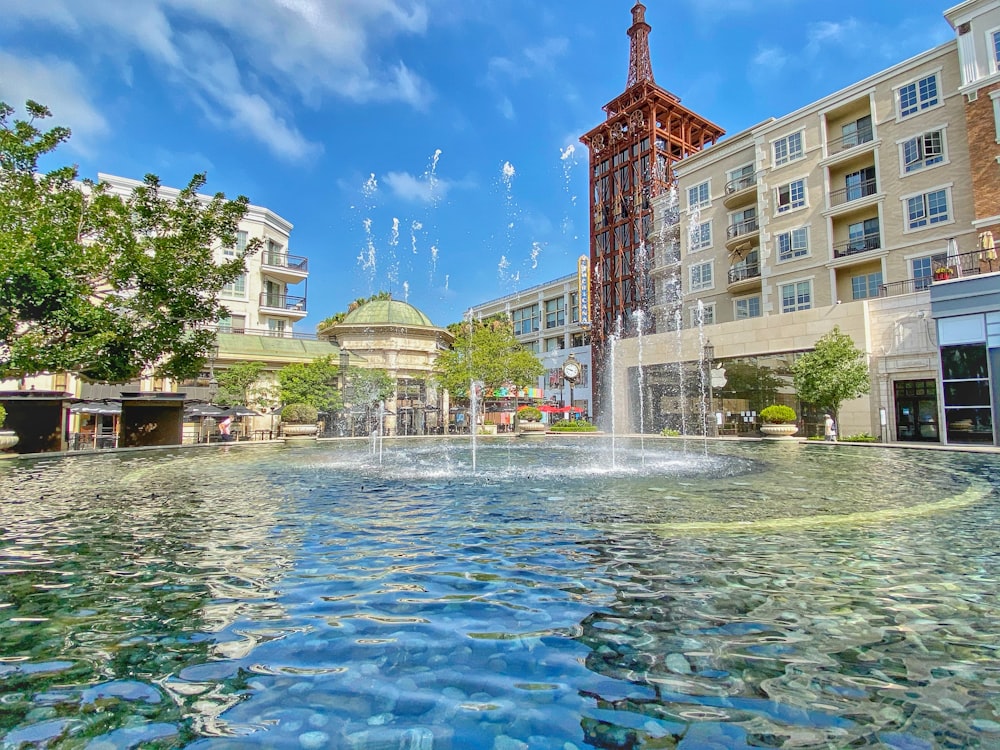 water fountain in front of brown concrete building during daytime