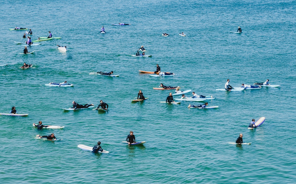 people riding on white boat on sea during daytime