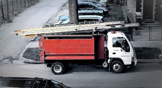 red and white truck on road during daytime
