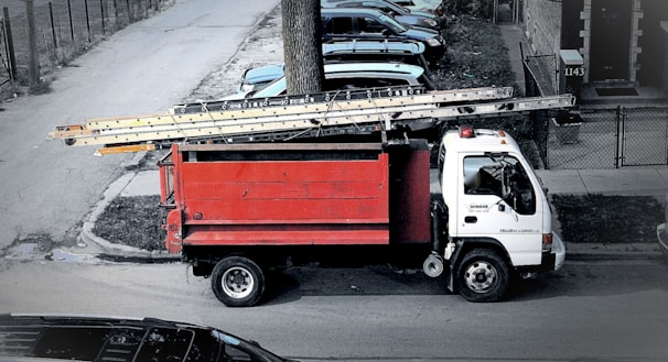 red and white truck on road during daytime