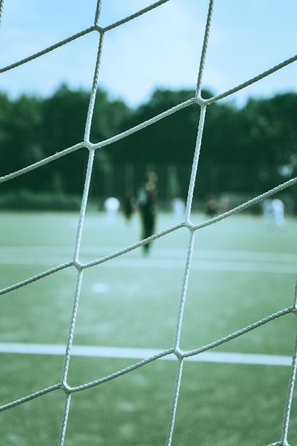 person in black shirt standing on green field during daytime