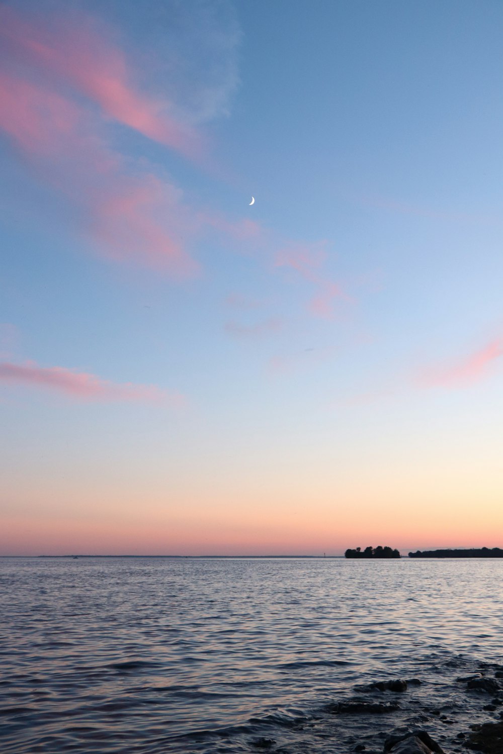 body of water under blue sky during daytime