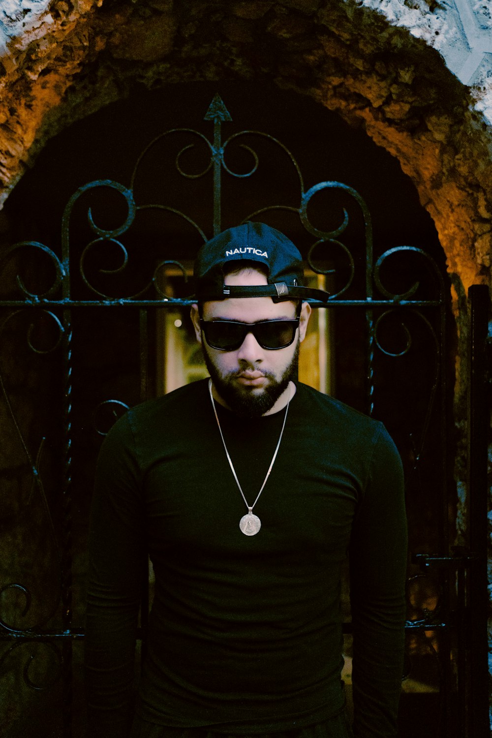 man in black long sleeve shirt wearing black sunglasses