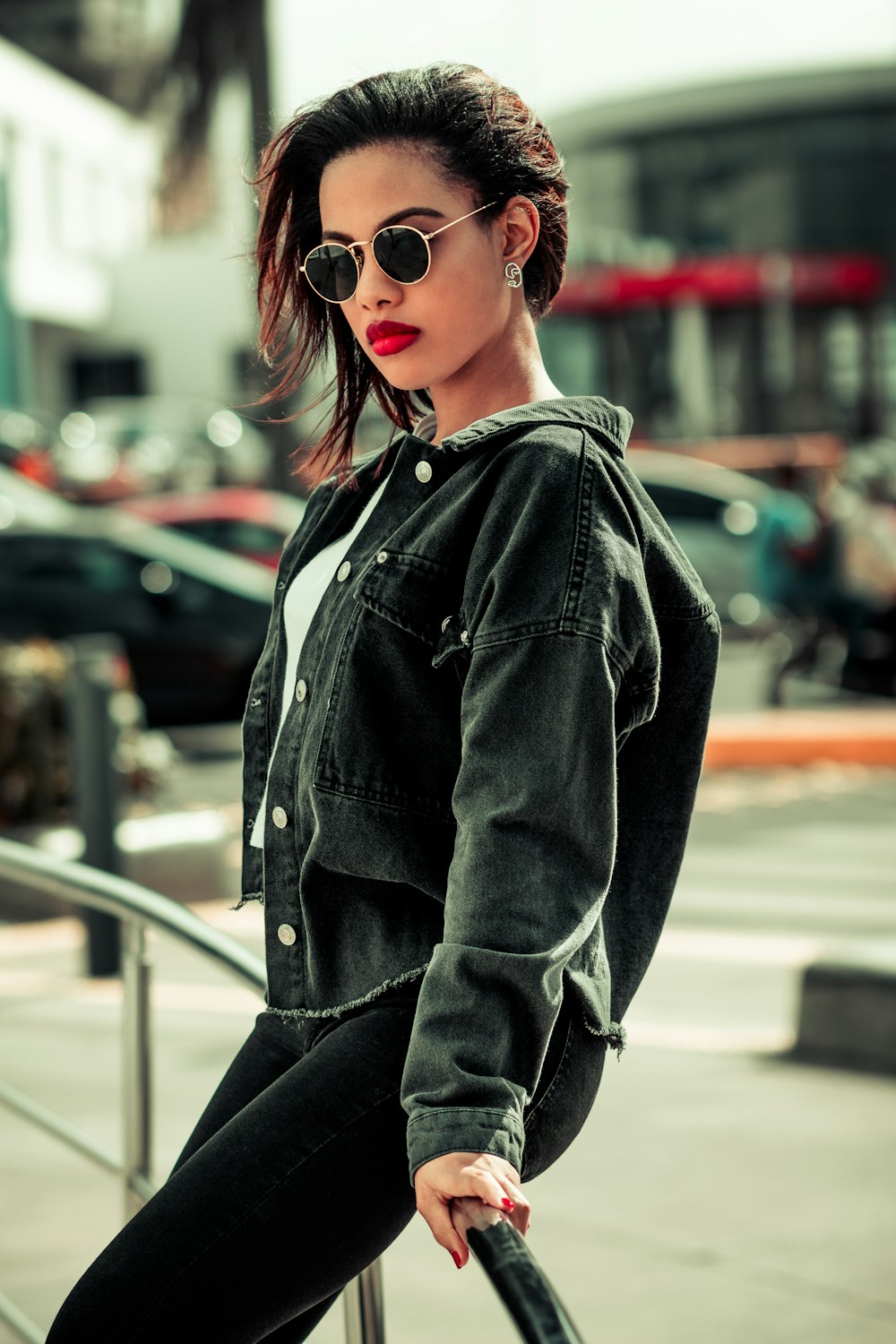 woman in black denim jacket wearing sunglasses