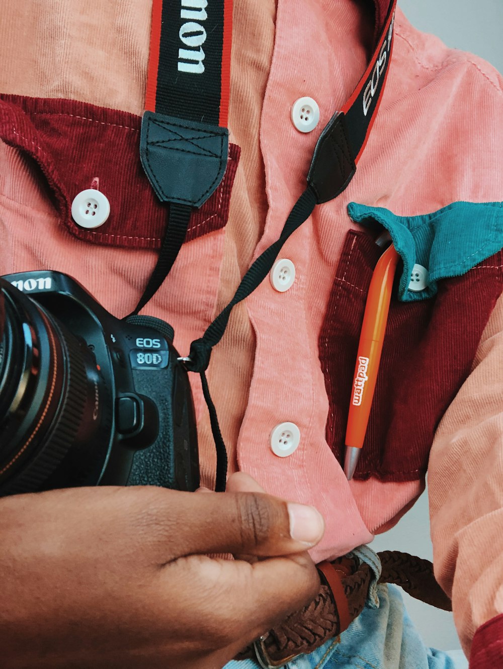 black nikon dslr camera on red textile