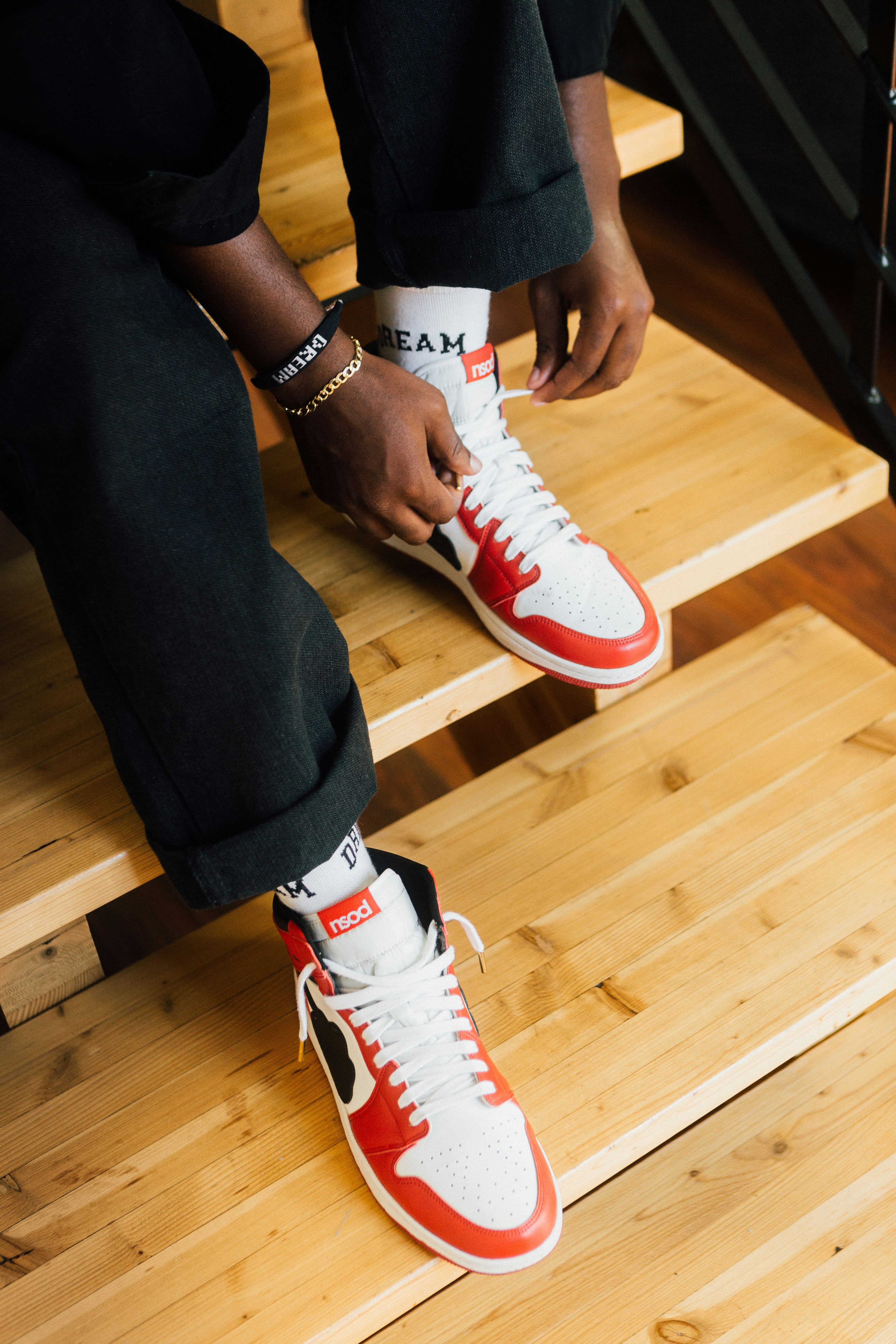 person wearing red and white nike sneakers