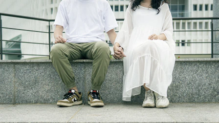 man in white dress shirt sitting on white bench