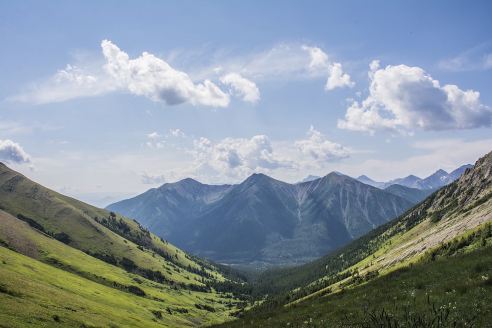 green mountains under white clouds during daytime