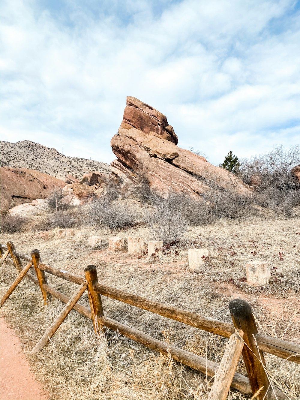 brown wooden fence near brown rock formation during daytime