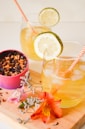 clear drinking glass with yellow liquid and sliced lemon