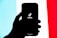 A silhouetted hand holds a smartphone displaying the TikTok logo on its screen, set against a tricolor background of light blue, white, and red.