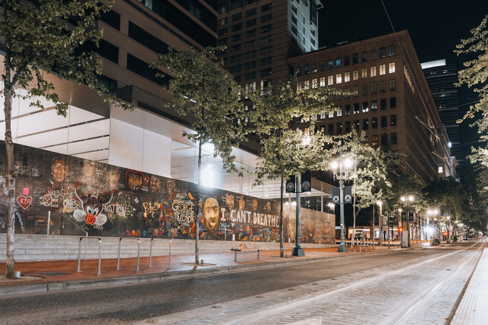 people walking on sidewalk near building during nighttime