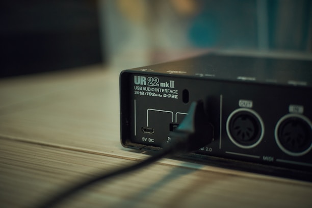 black and silver electronic device on brown wooden table