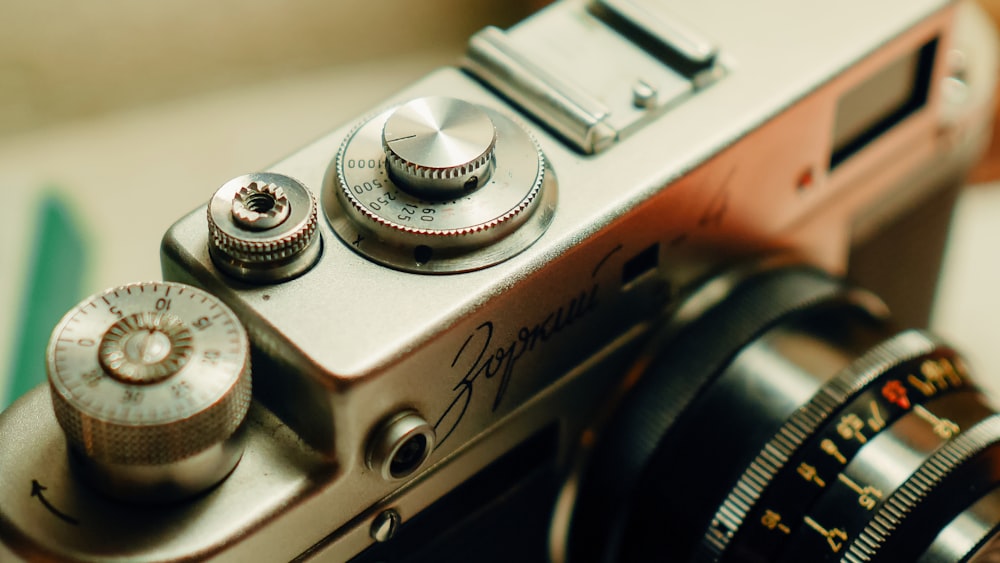 silver and black camera on brown wooden table