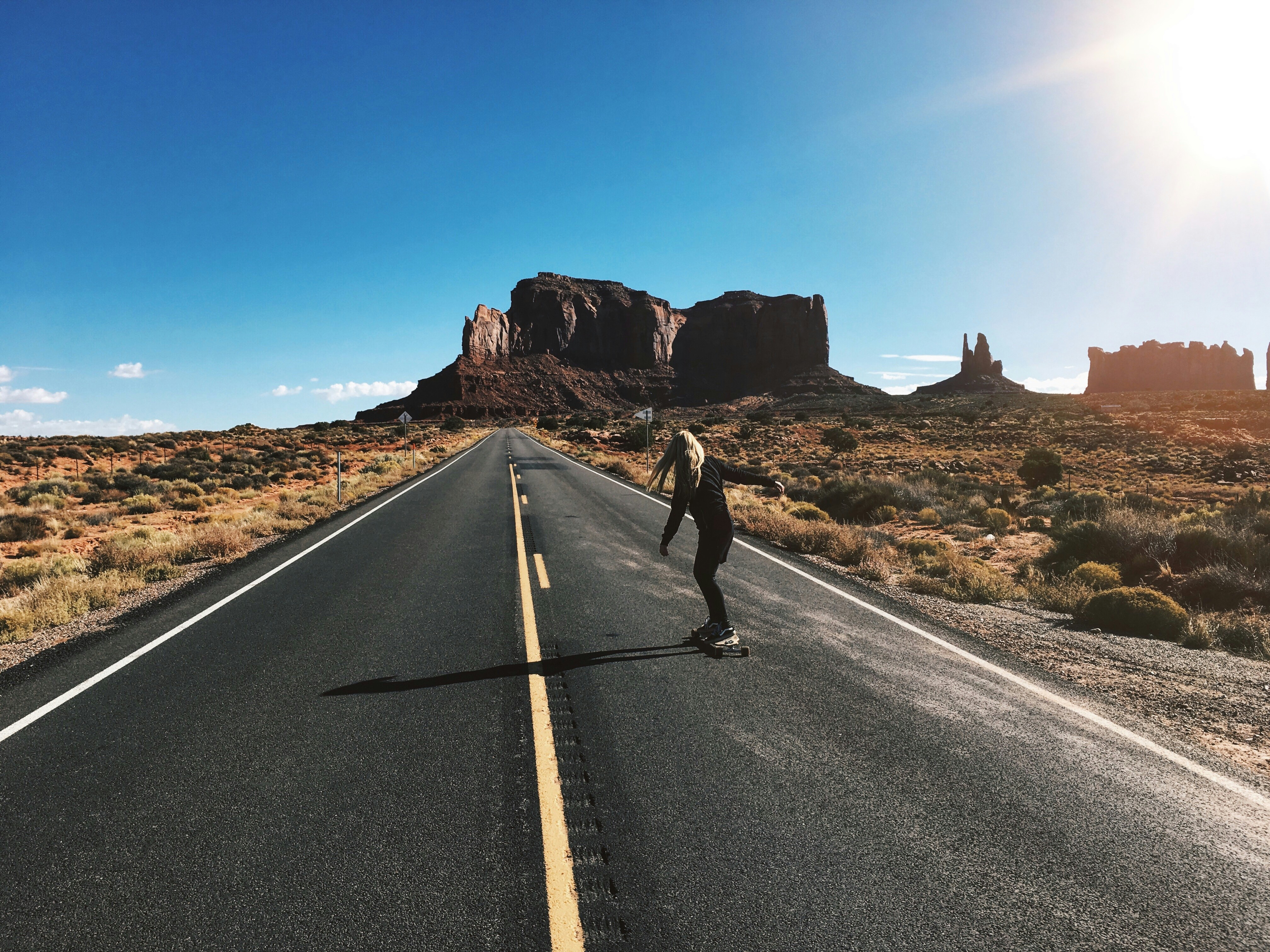 man in black jacket and black pants running on gray asphalt road during daytime, 