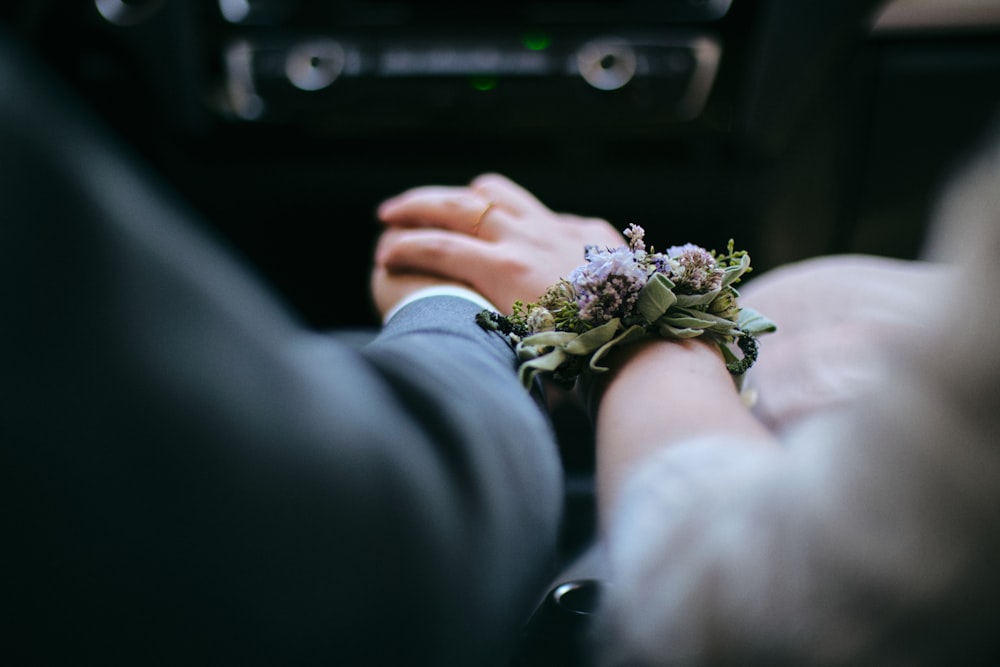 person holding white and green flower