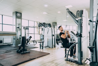 woman in black tank top and black pants exercising