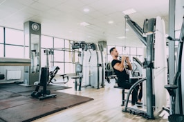 woman in black tank top and black pants exercising
