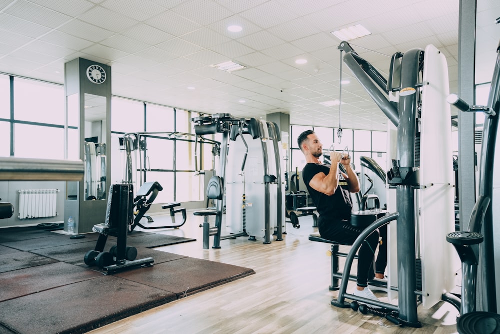 woman in black tank top and black pants exercising