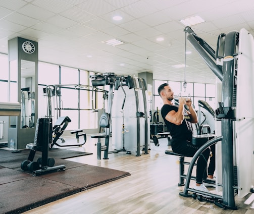 woman in black tank top and black pants exercising