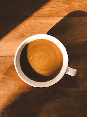 Minimalist and elegant coffee cup on a wooden table with soft morning light