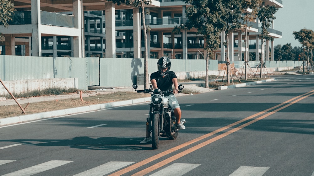 man in black jacket riding motorcycle on road during daytime