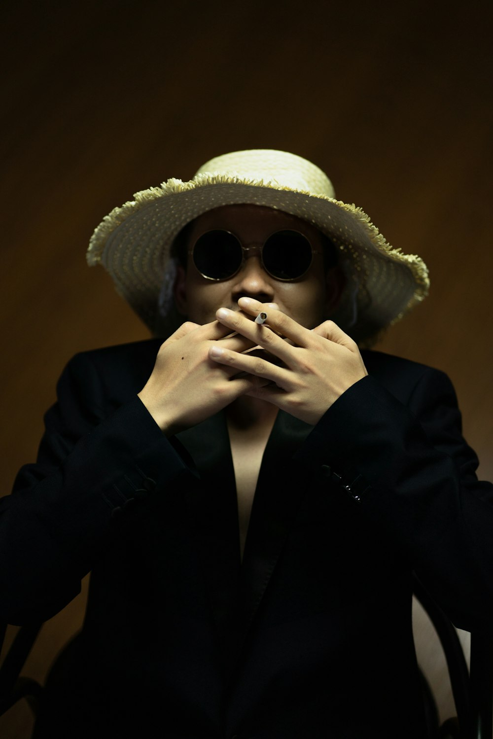 woman in black blazer wearing white sun hat