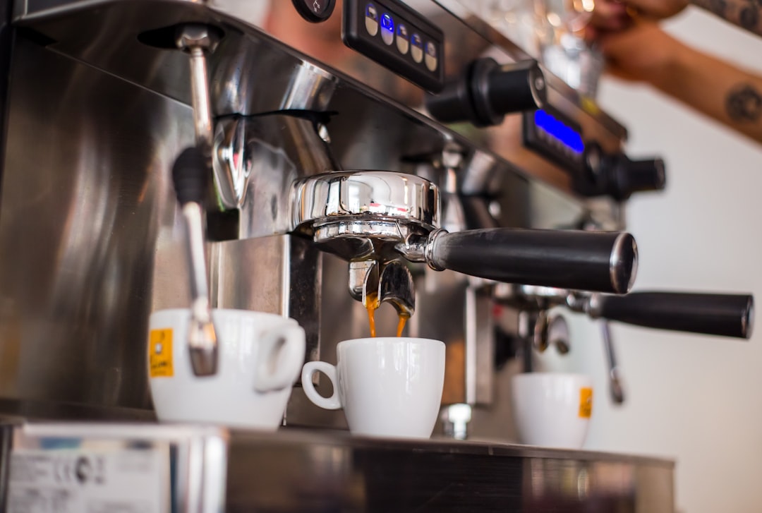 white ceramic mugs on silver espresso machine