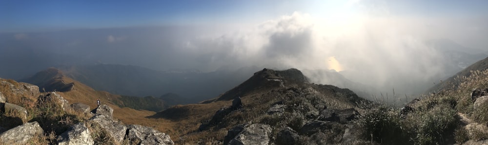 brown and green mountain under white clouds during daytime