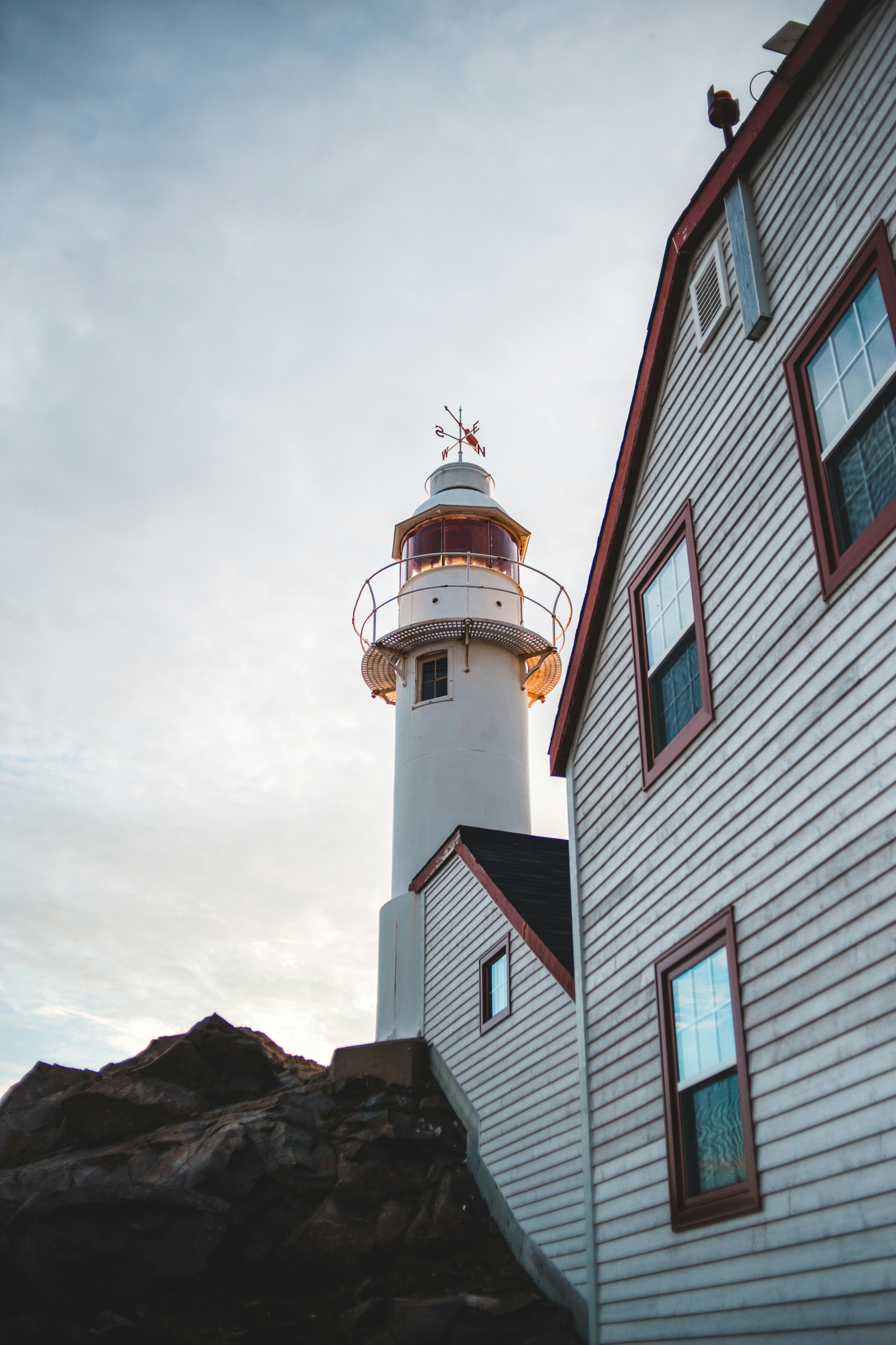 white and brown concrete lighthouse under cloudy sky during daytime