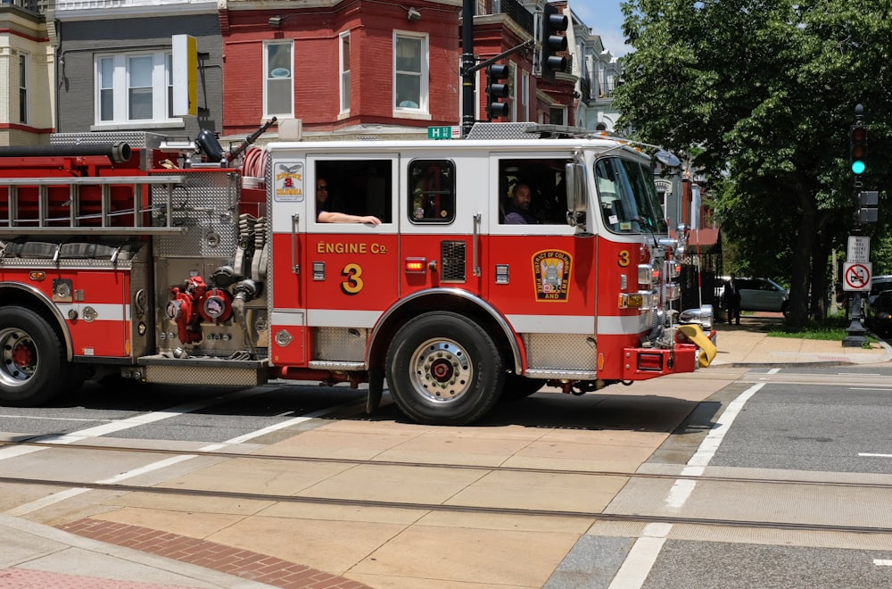 red and white fire truck on road during daytime