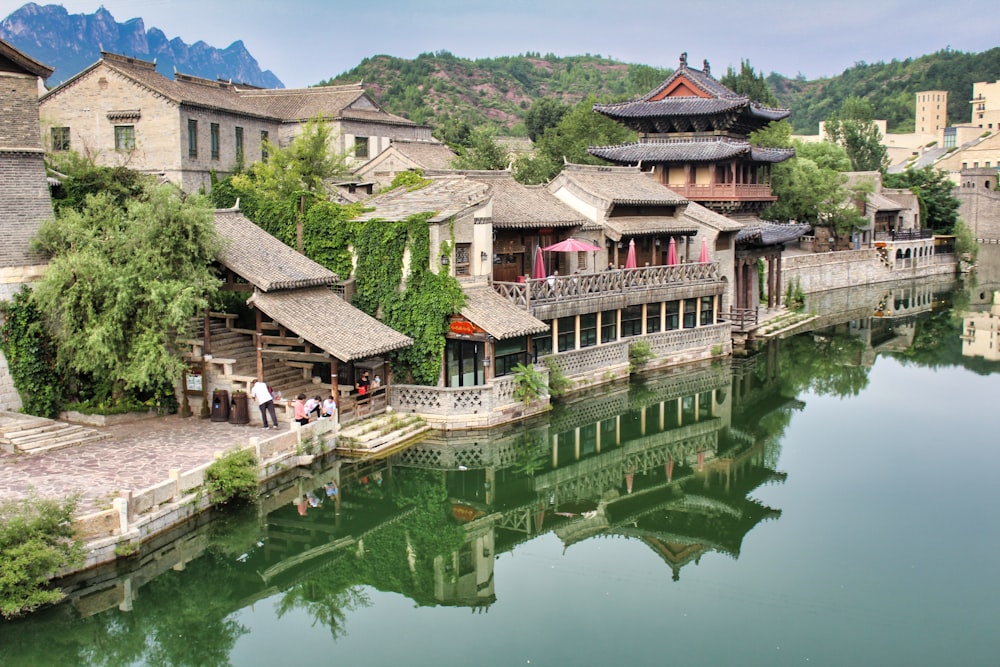 brown and white wooden house on body of water during daytime