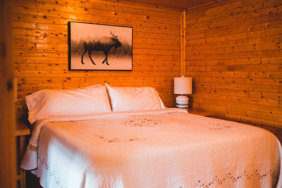 white bed linen with white table lamp