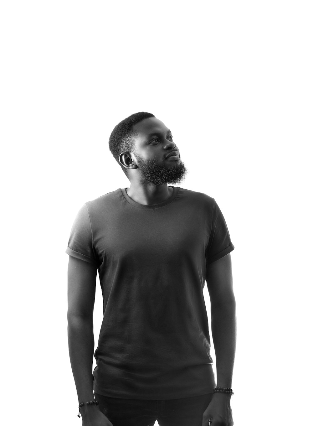 a man with a beard standing in front of a white background