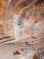Drone surveying a large open-pit mine, capturing volumetric data with precision.