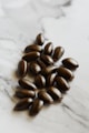 brown coffee beans on white surface