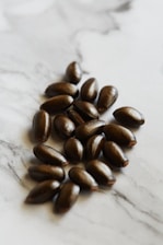 brown coffee beans on white surface