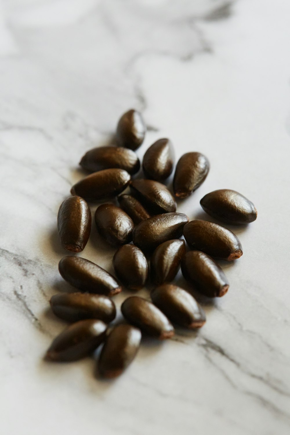 brown coffee beans on white surface