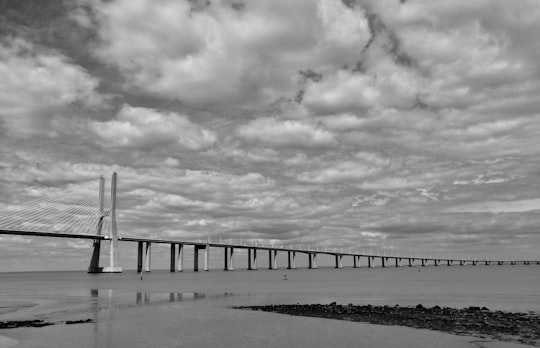 grayscale photo of bridge over the sea in Parque das Nações Portugal