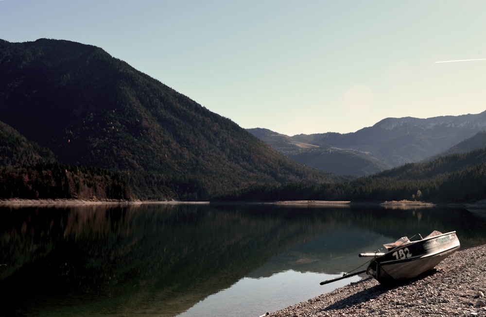 boat on river near mountain during daytime