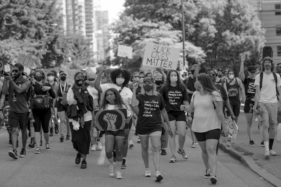 grayscale photo of group of people on street