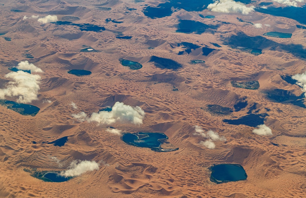 an aerial view of sand dunes and clouds