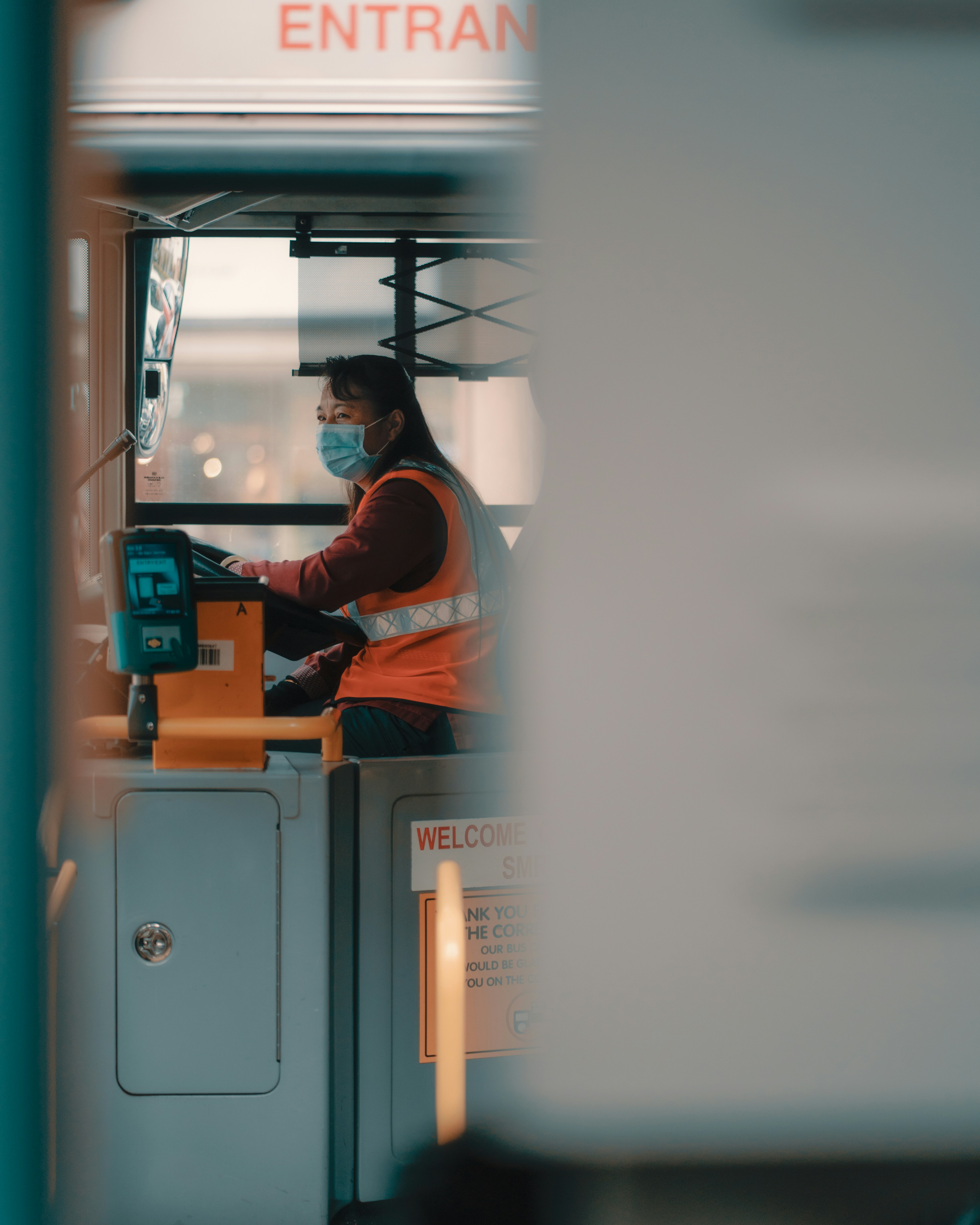 man in orange jacket sitting on gray metal frame