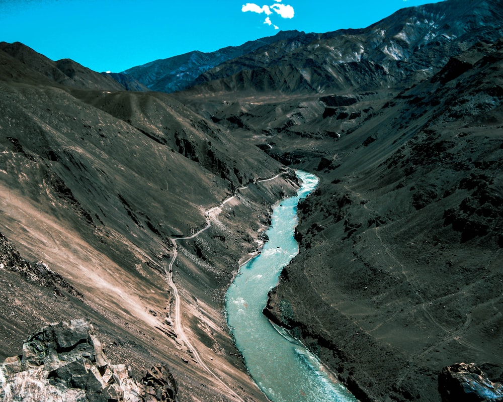 river between mountains during daytime