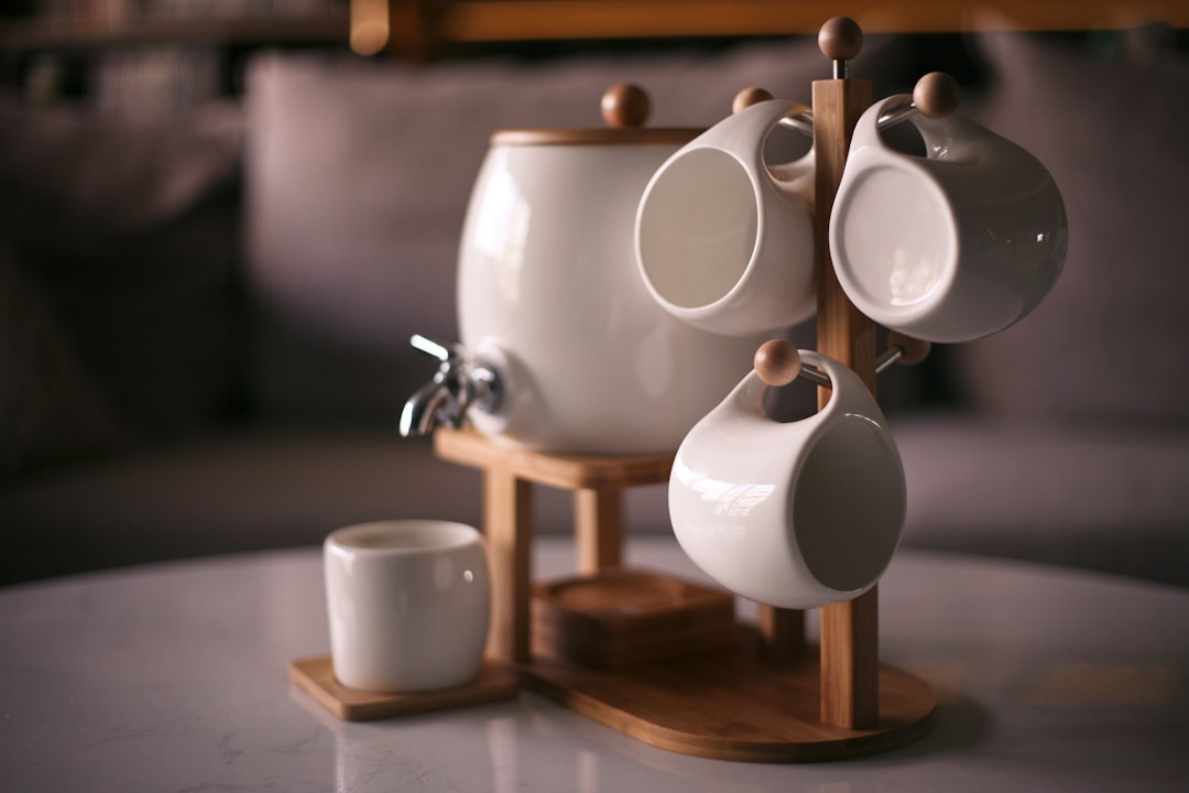 white ceramic mugs on brown wooden table